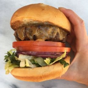 Gluten-free Traditional Cheeseburger with tomatoes, lettuce, onions